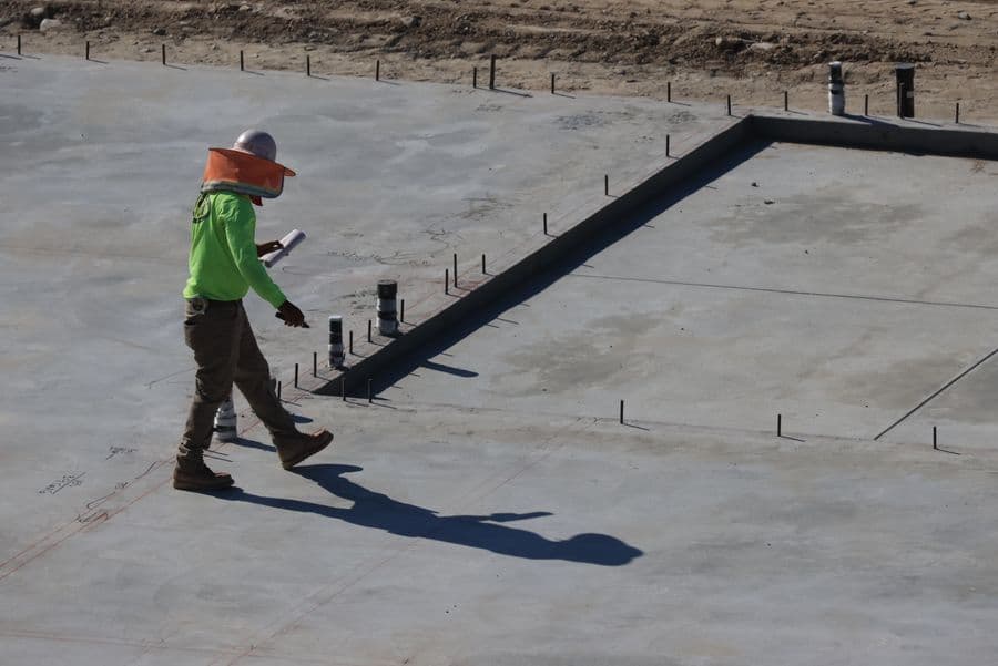 Engineer inspecting a concrete slab at a construction site
